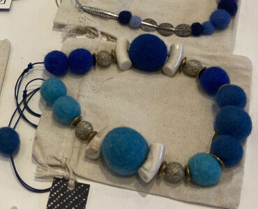 Wool, hematite and ceramic necklaces with drawstring purses